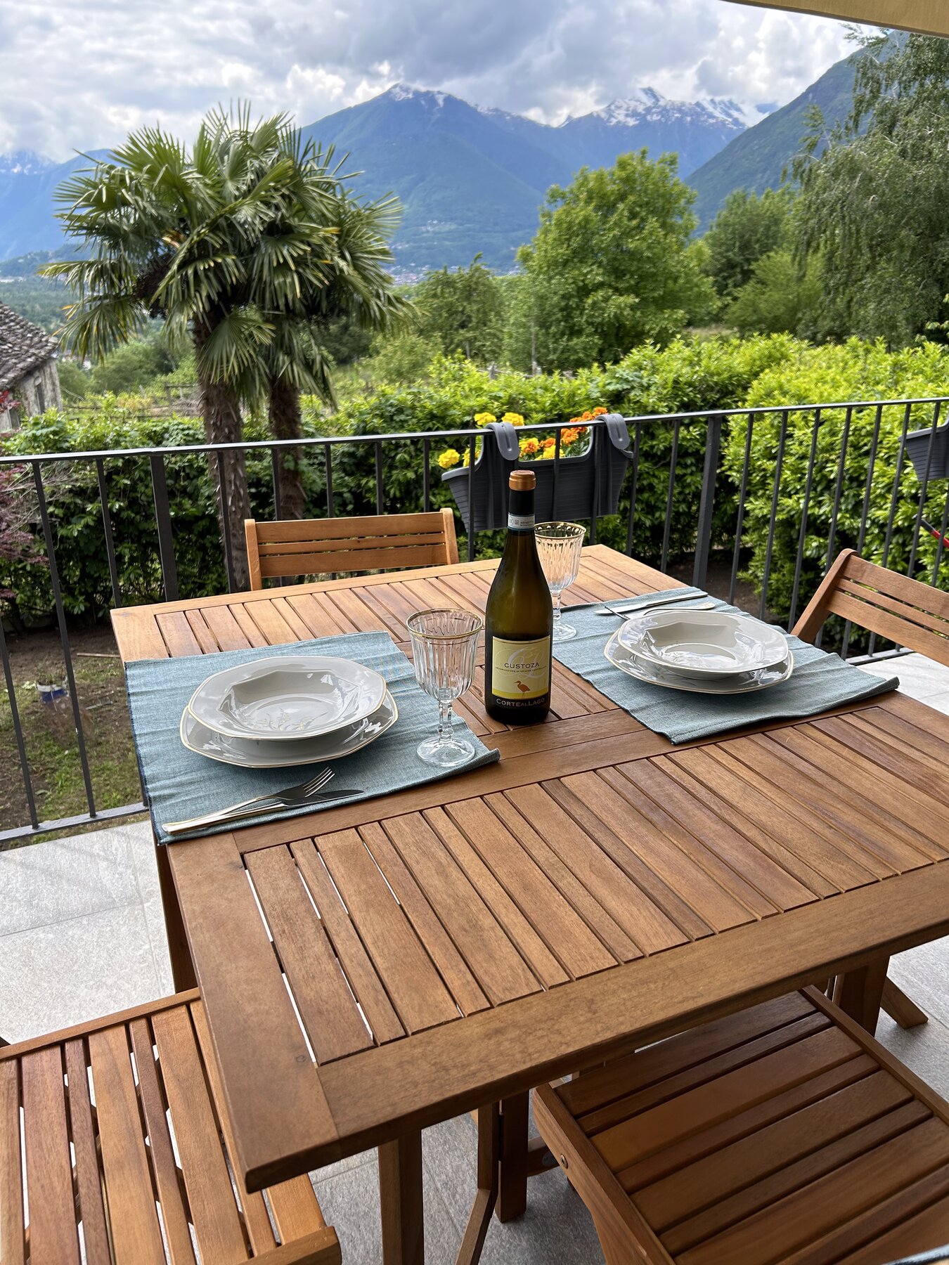 Terrazza con tavolo apparecchiato e bottiglia di vino locale